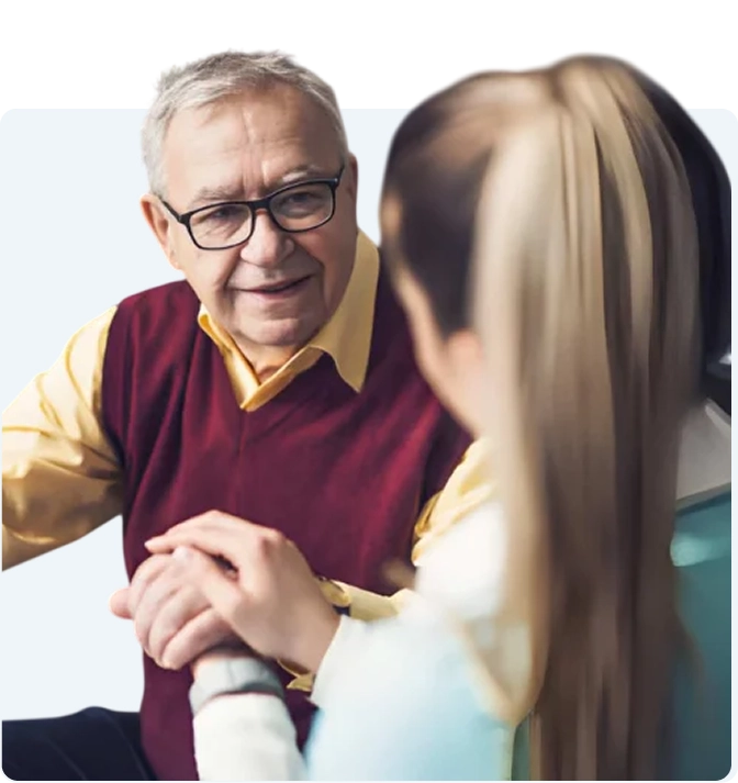Caregiver sitting with senior woman at home
