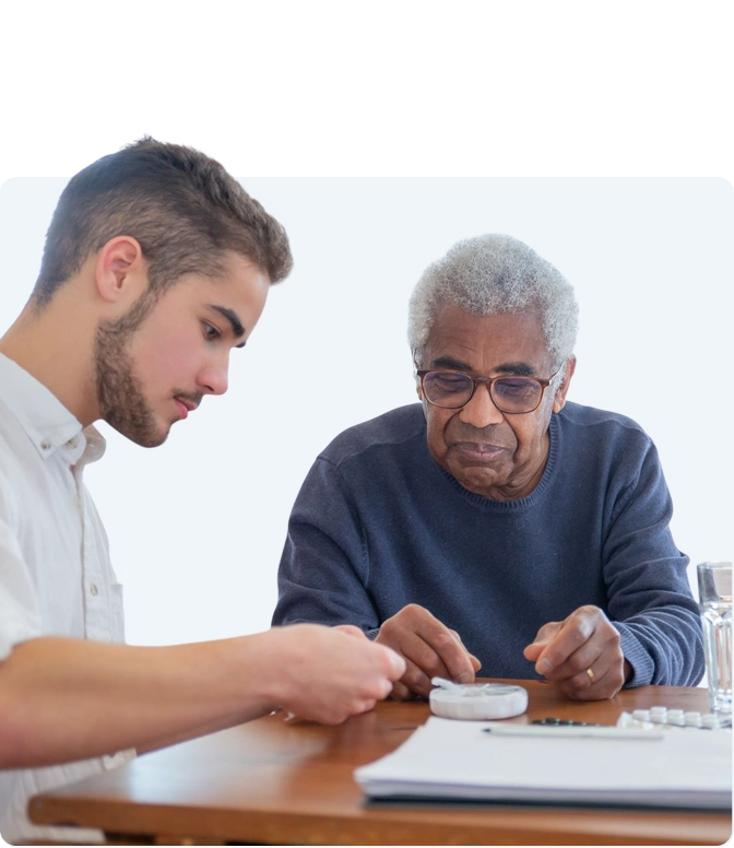 Caregiver sitting with senior woman at home