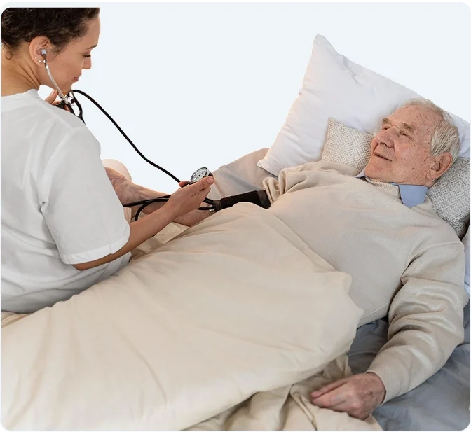 Caregiver sitting with senior woman at home
