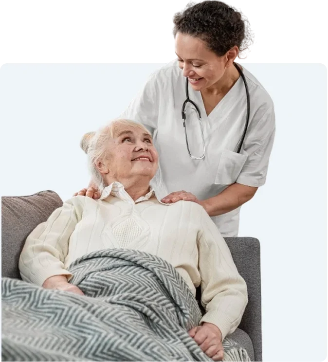 Caregiver sitting with senior woman at home